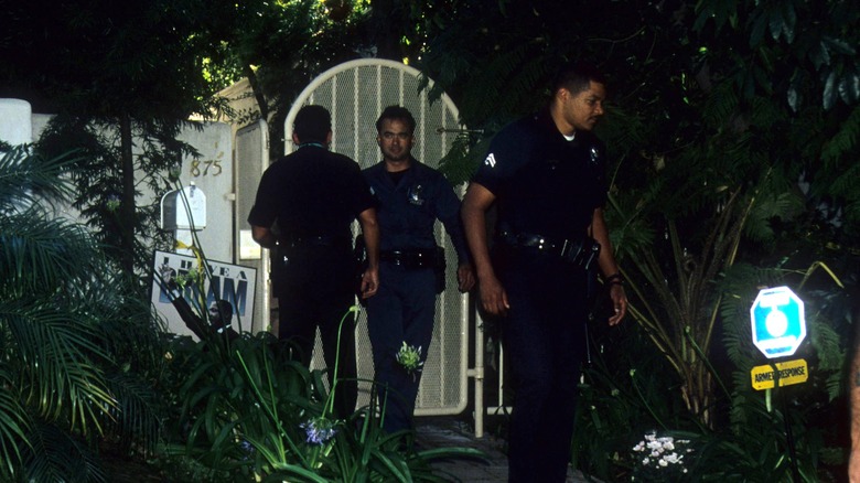 Police officers investigate the scene of Nicole Brown Simpson's murder