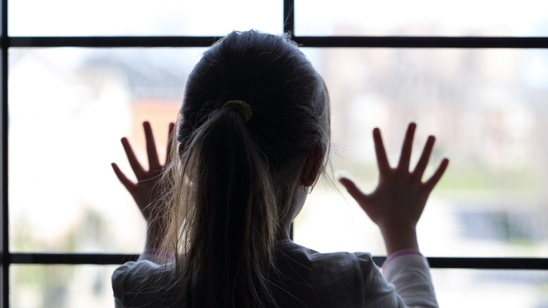 child looking out window