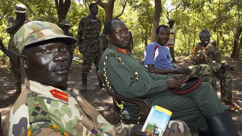 joseph kony sitting with members of the LRA in forest