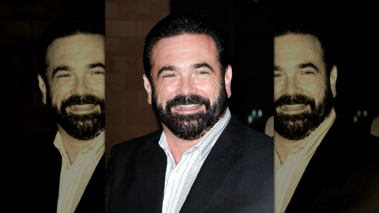 Billy Mays in a suit and white shirt smiling