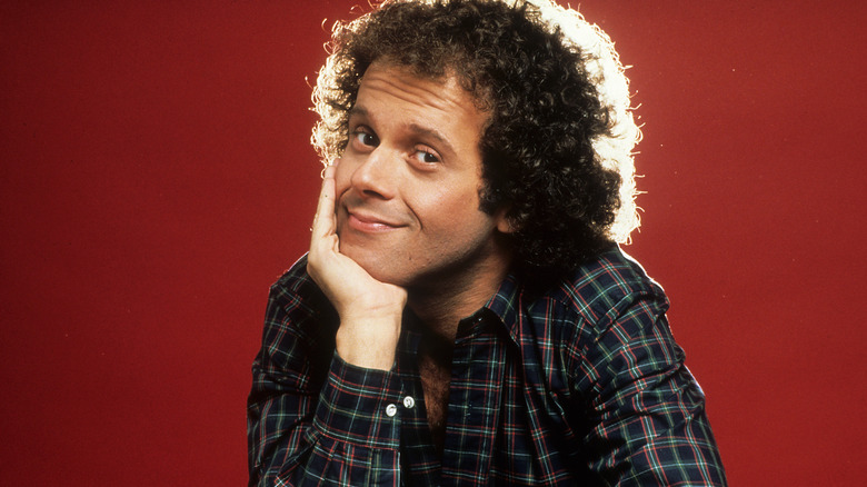 Richard Simmons posing against a red background