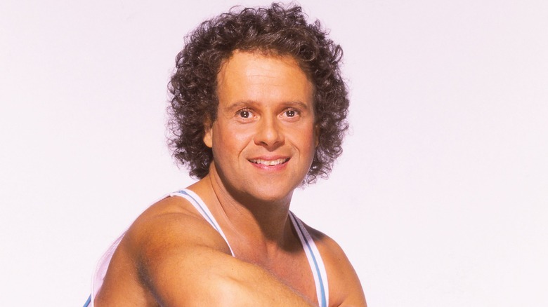 Richard Simmons in a tank top posing for a photo