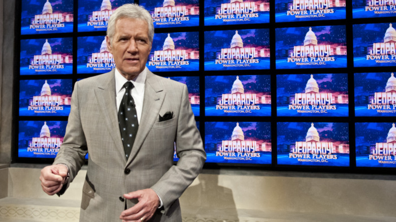 Alex Trebek in front of the Jeopardy board 