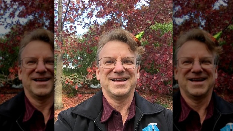 Chris Espinosa smiling black jacket outdoors