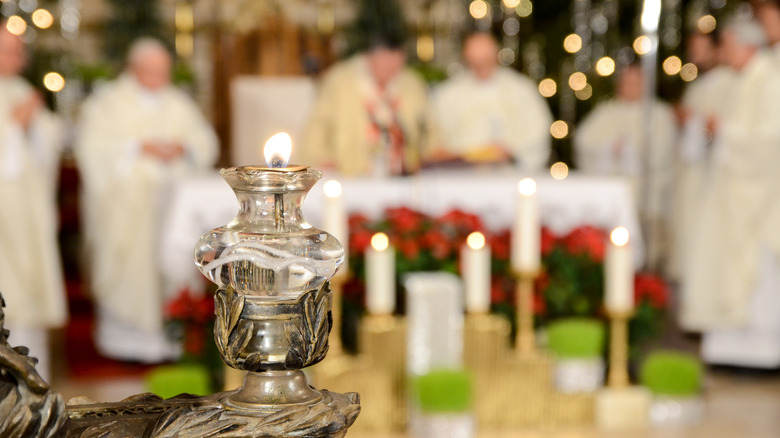 Midnight Mass priests and candle