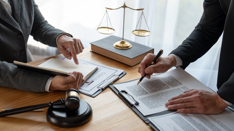 People signing legal documents