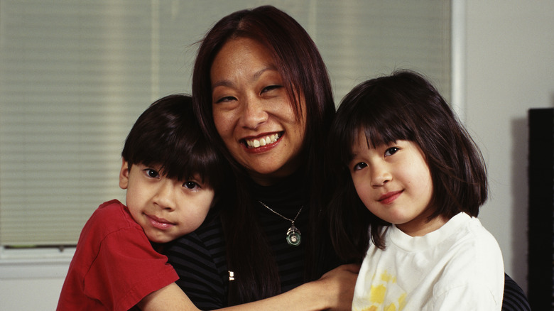 May Pang posing with her children