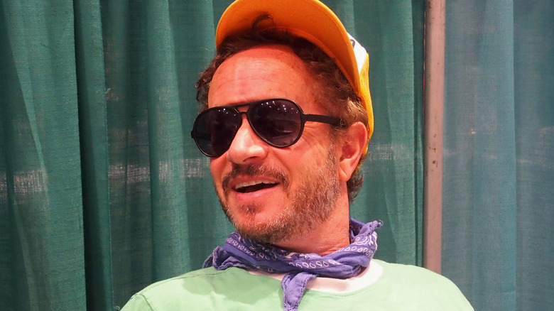 Pauly Shore hat sunglasses smirking