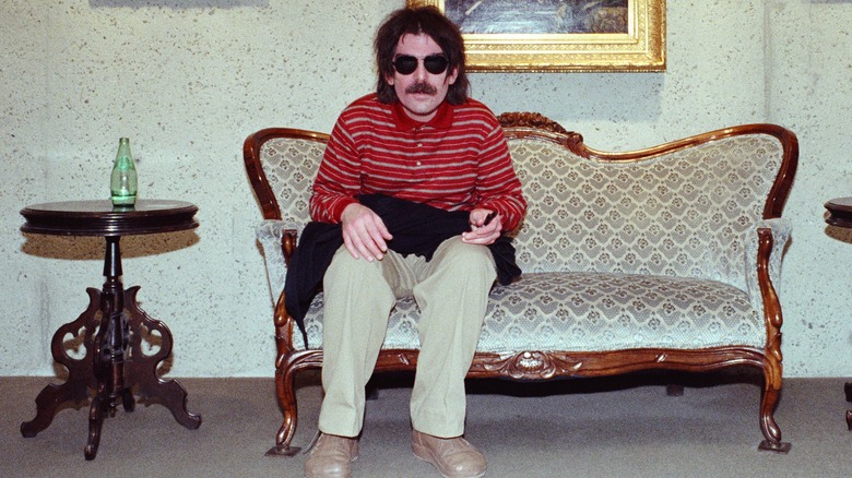 Captain Beefheart on a vintage couch in sunglasses