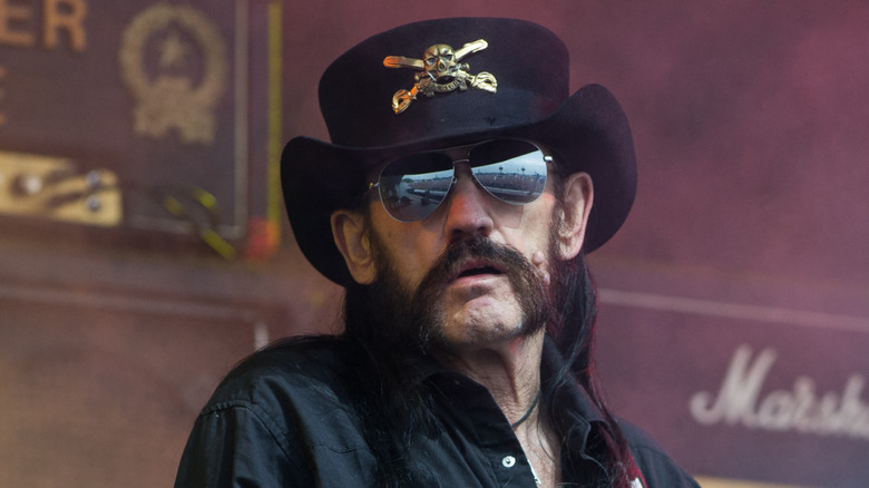 lemmy kilmister wearing sunglasses and scowling on stage