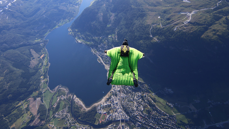 Person base jumping in wingsuit