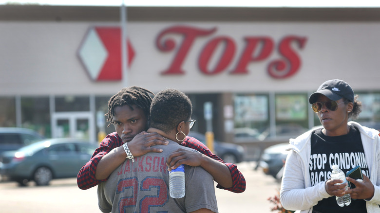 People gather outside Tops Friendly Market 