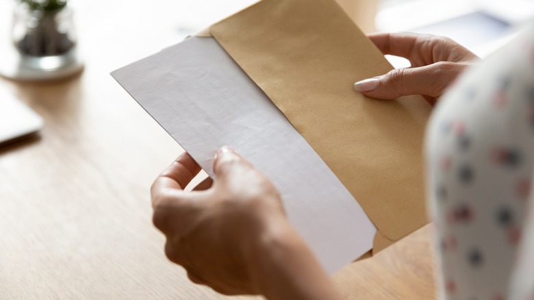 woman opening letter