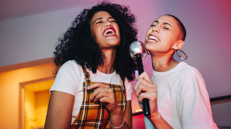 Two women singing karaoke