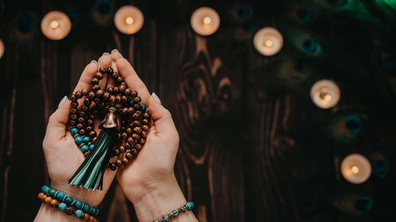 Praying woman holding mala