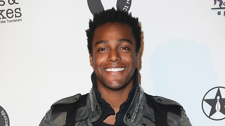 Austin Brown smiles on the red carpet at an event