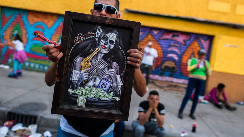 Artist displaying Santa Muerte picture