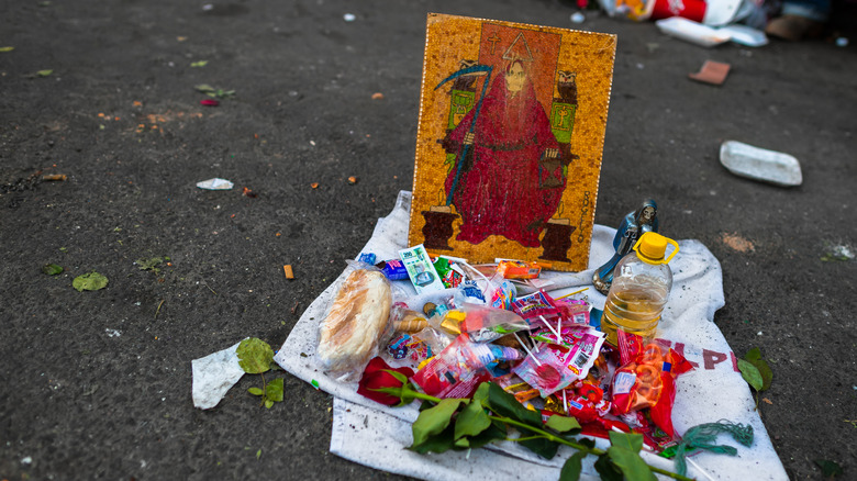 Santa Muerte street shrine with offerings