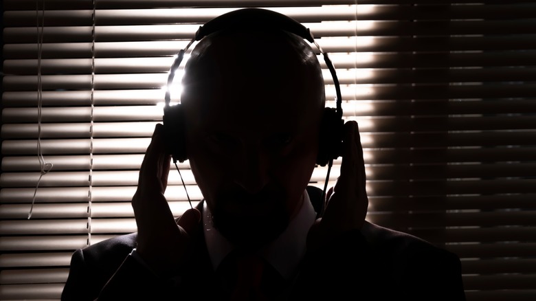A shadowy figure with a headset on