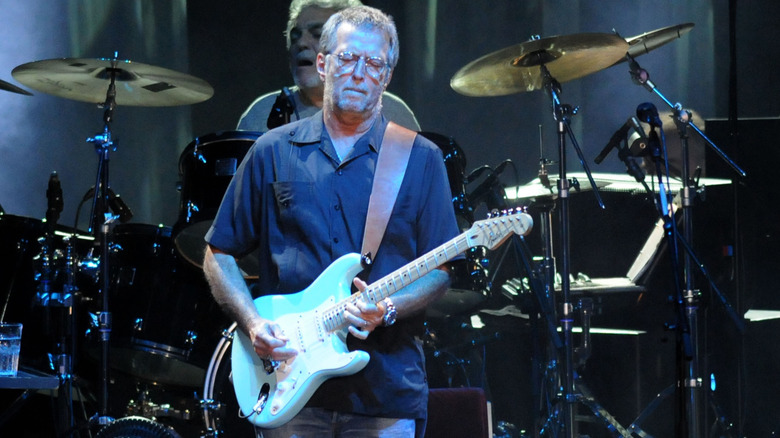 Eric Clapton playing guitar on stage