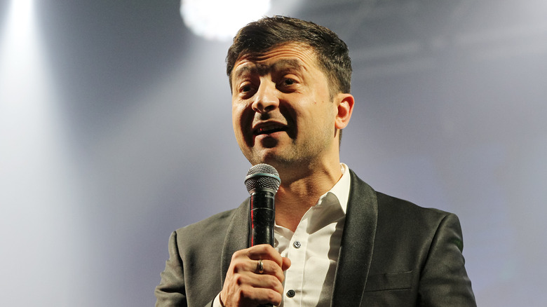 Volodymyr Zelensky holding microphone