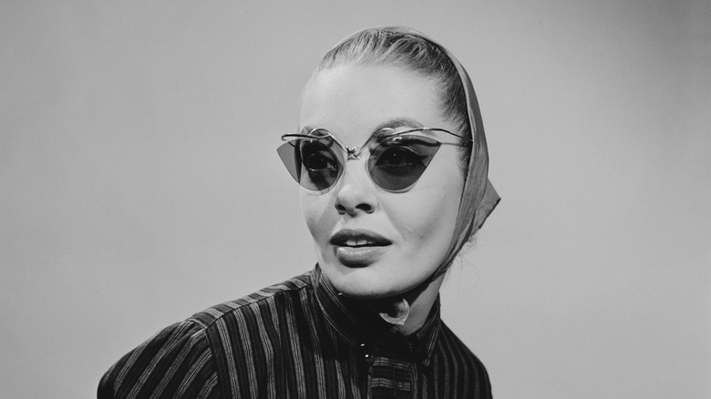 Woman in cat-eye glasses and head scarf