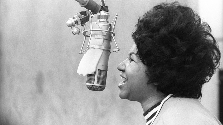 Aretha Franklin singing at microphone