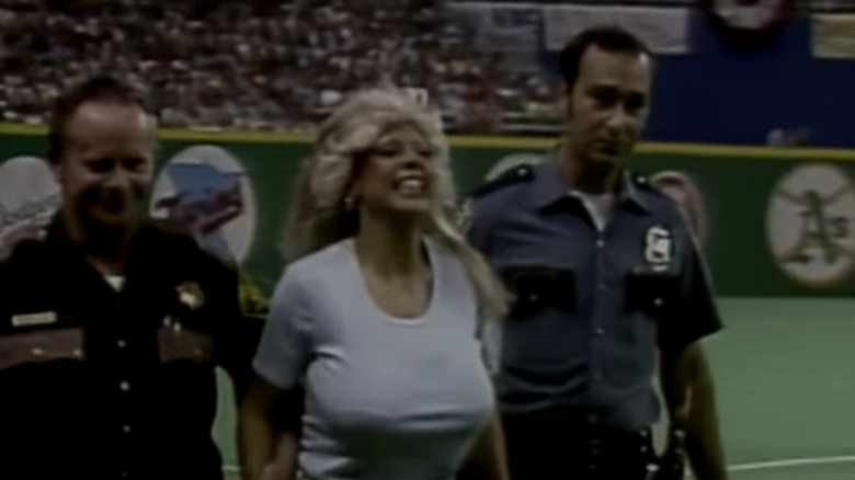 Morganna The Kissing Bandit escorted from baseball field, 1979