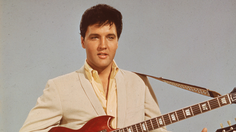 Elvis Presley standing with guitar