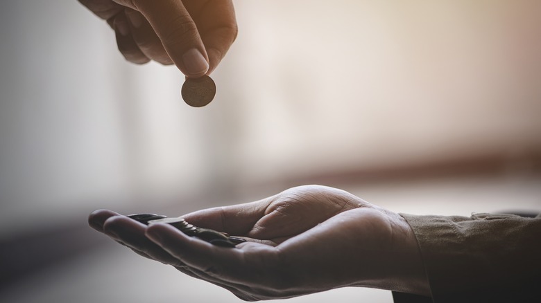 hand holding coins