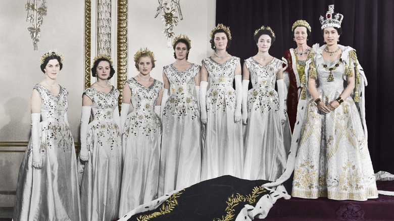 Queen Elizabeth II posing with maids of honour