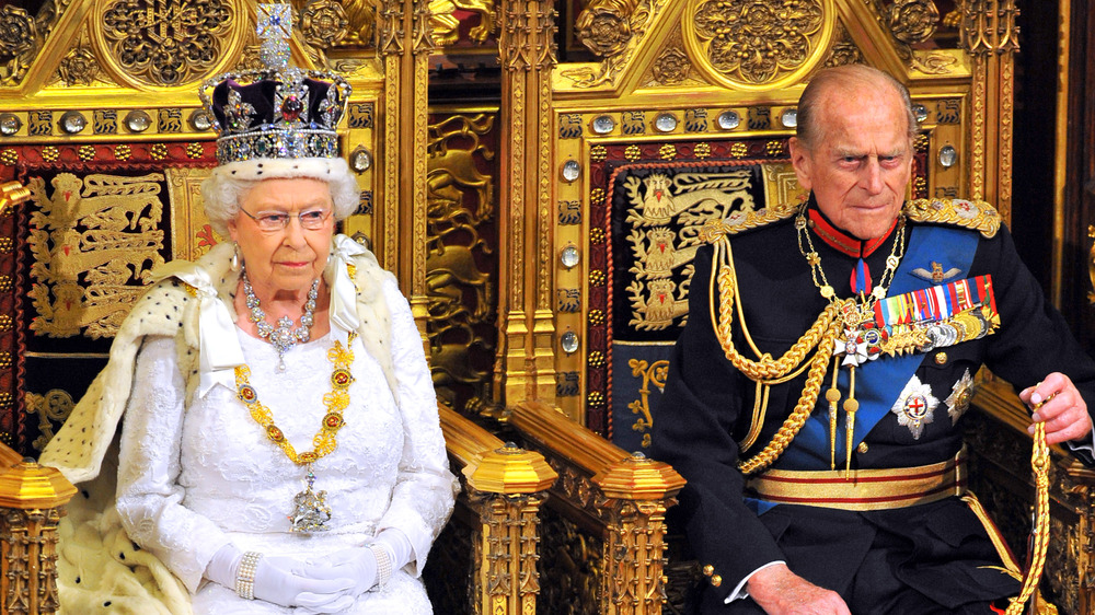 Queen Elizabeth II and Prince Philip on thrones at the opening of Parliament