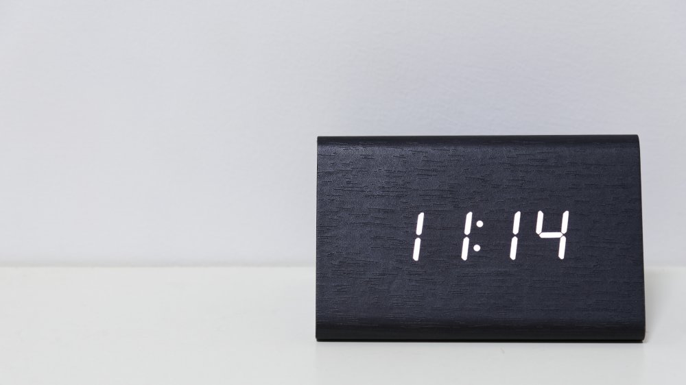 Black digital clock on a white background showing time 11:14 