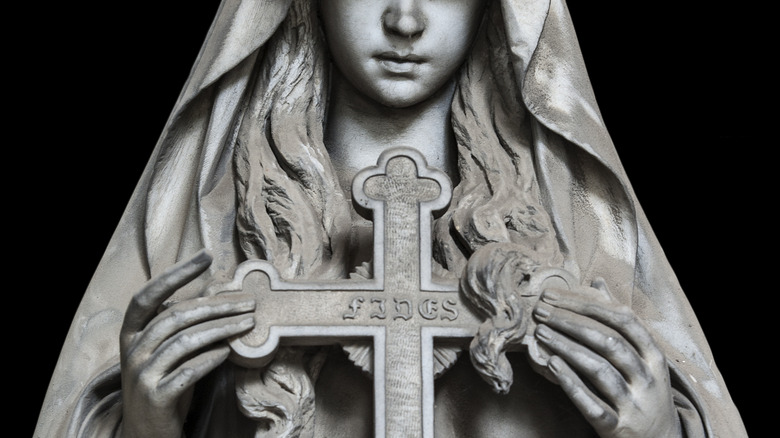 Nun statue holding cross