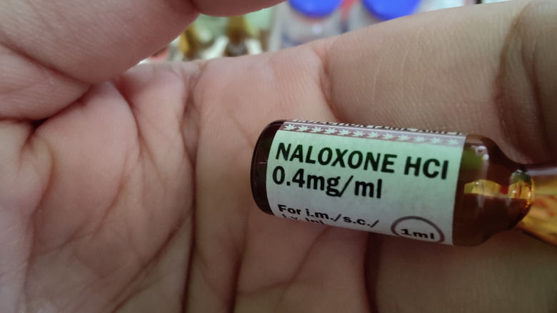 Naloxone bottle held in hand