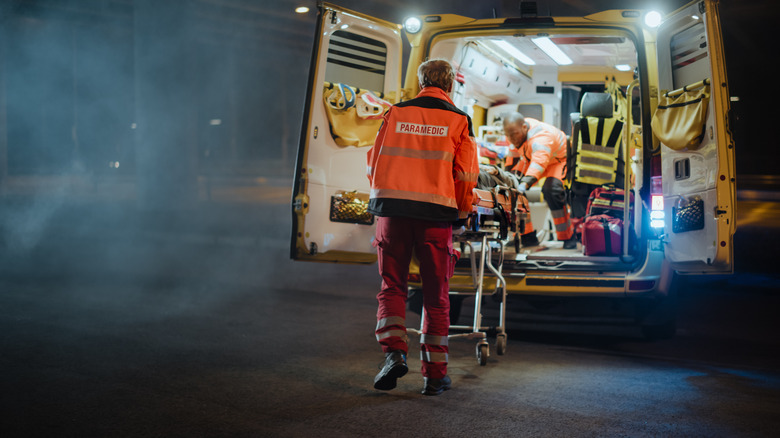 paramedics putting someone into the back of an ambulance