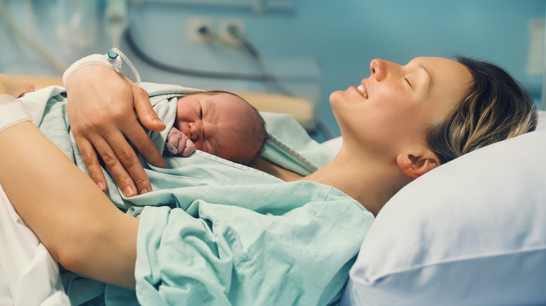 Mother holding newborn hospital setting