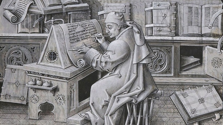 Medieval monk writing in scriptorium