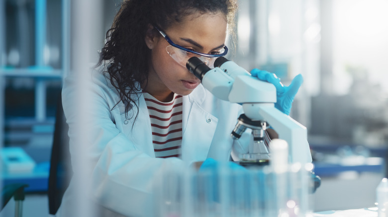 scientist looking into a microscope