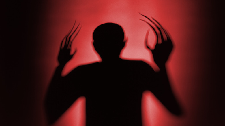 Creature with long fingers silhouette