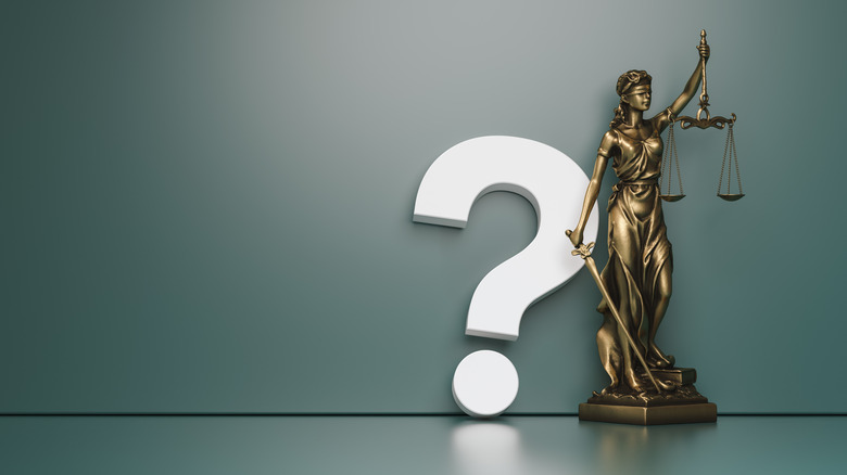 lady justice statue with question mark