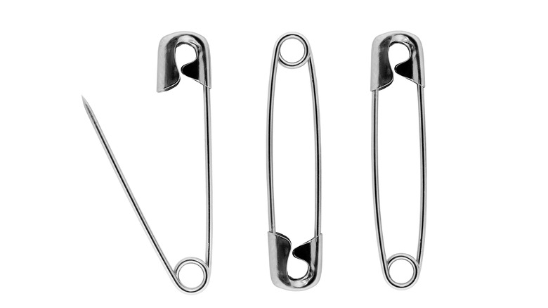 three safety pins grouped together