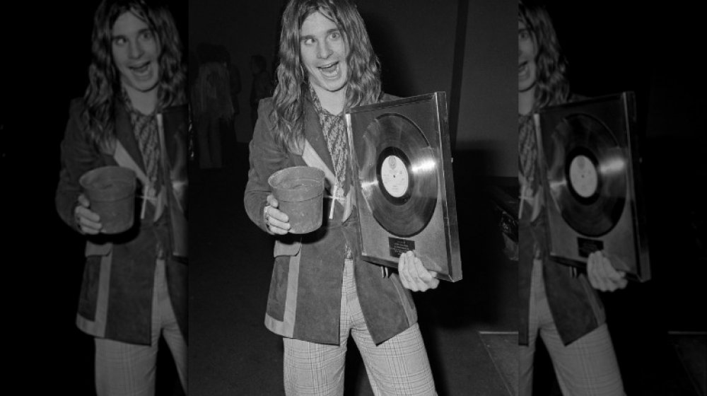 Ozzy Osbourne holding gold record