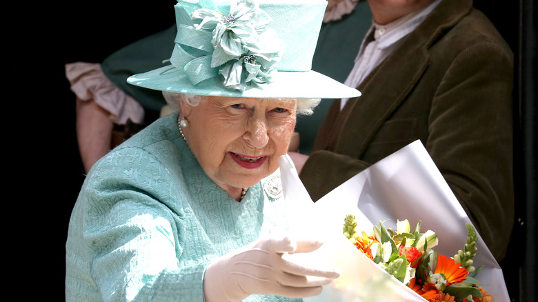 Queen Elizabeth II holding flowers