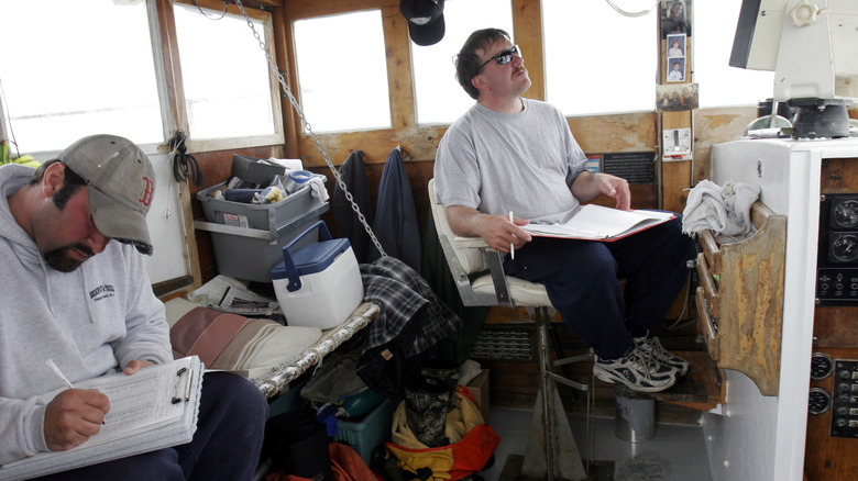 Two men operating fishing boat