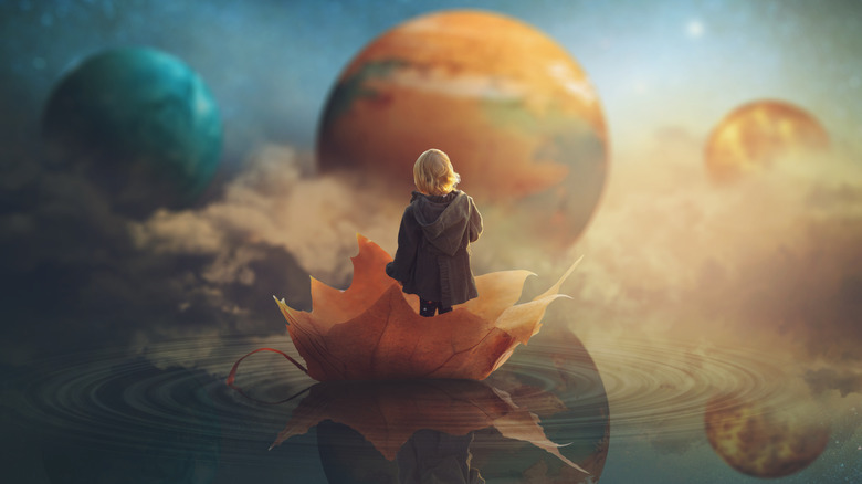 Girl on a leaf under planets
