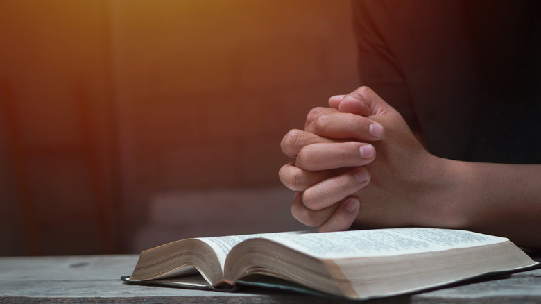 Person praying over Bible