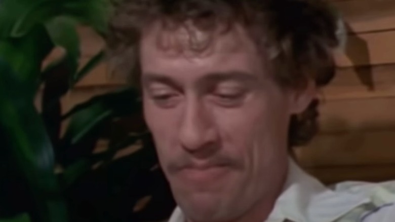 John Holmes smiling looking down