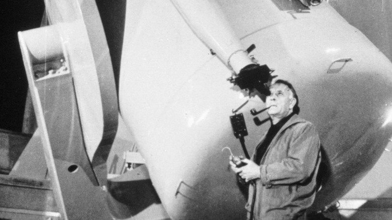 Edwin Hubble looking through telescope