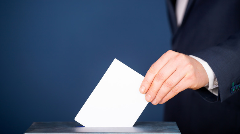 Man putting vote in ballot box